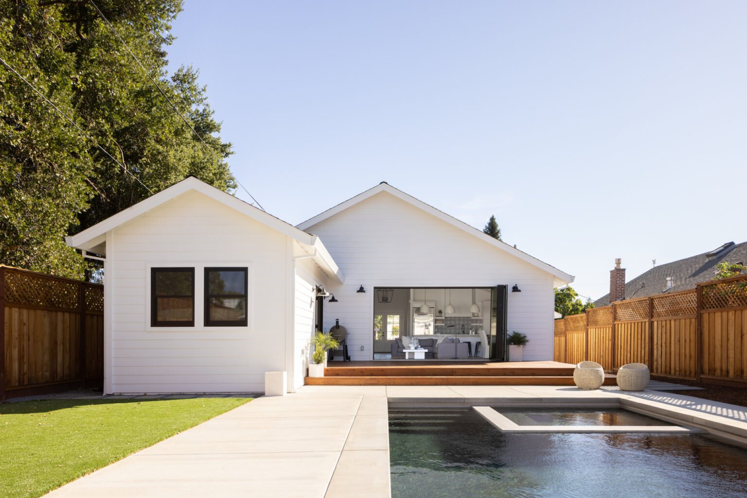Rear of home with open living area and pool